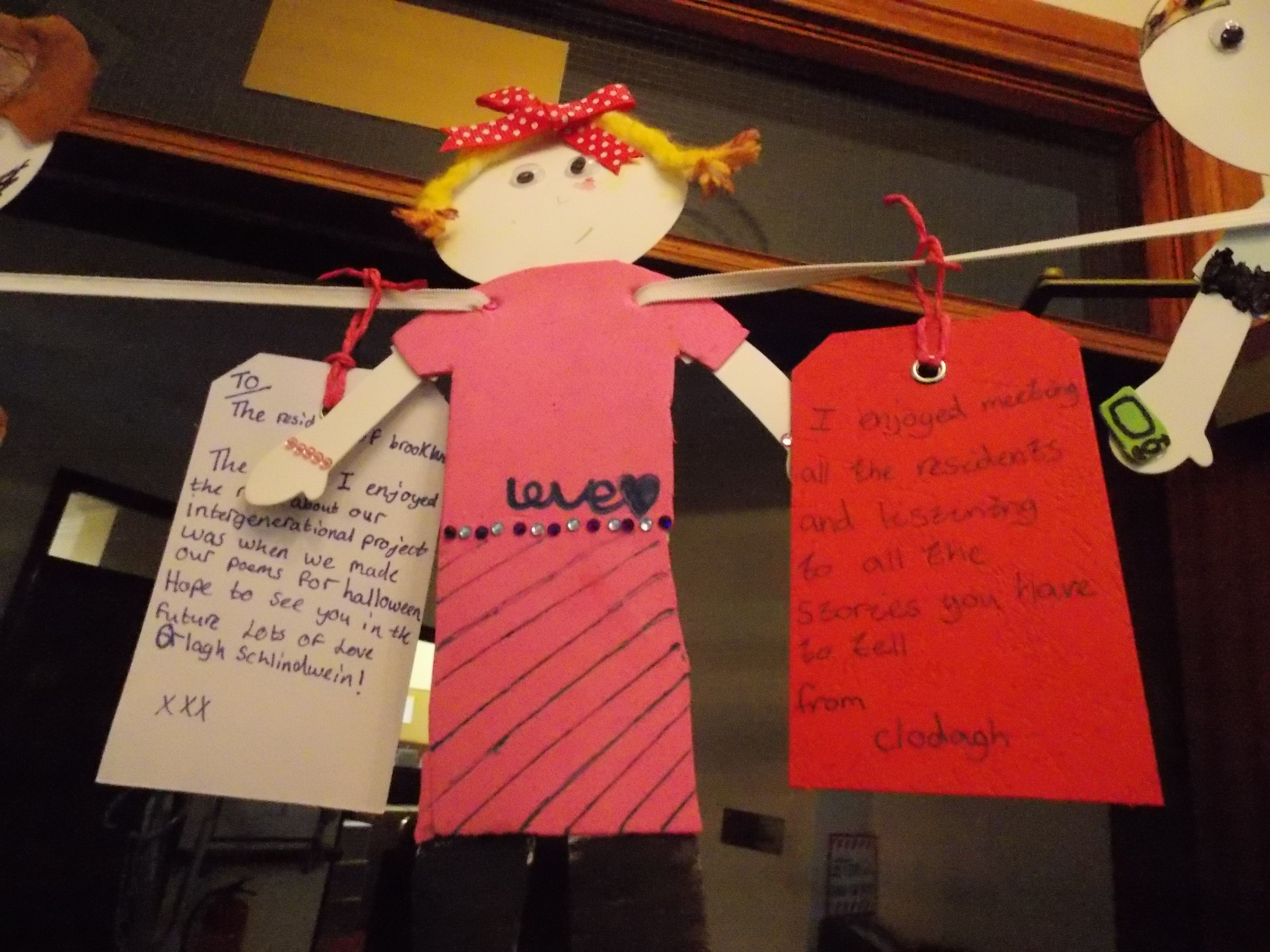 Paper doll garland with label