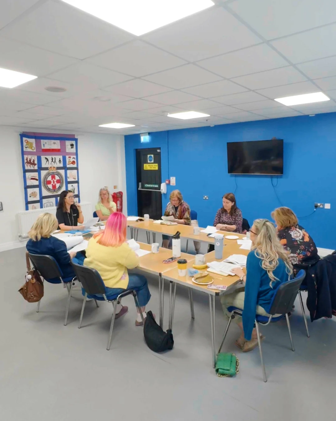 Women gathered around a table during a LEADER session